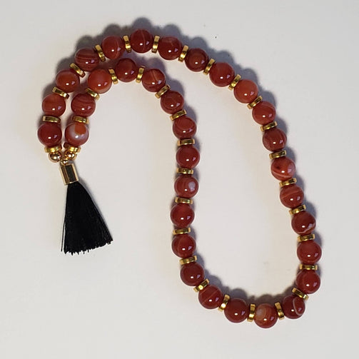 carnelian, small black tassel, gold accent